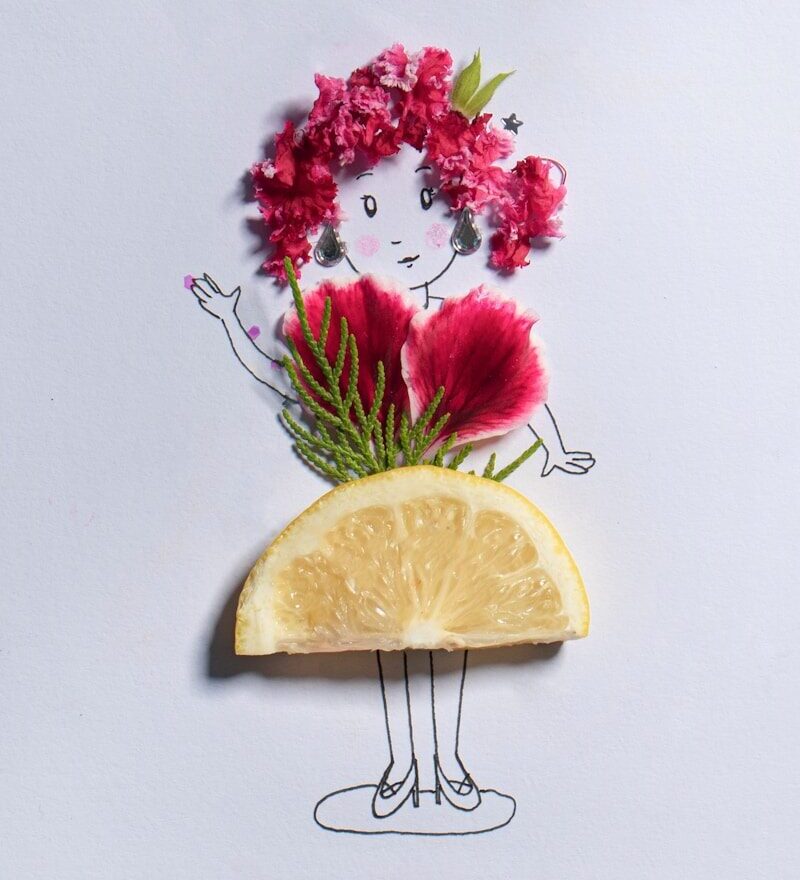 craft: a sliced lemon beside pink flowers made to look like a little girl